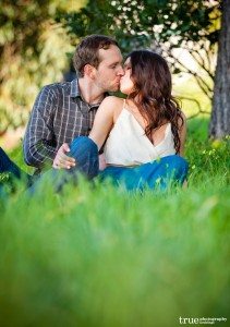 Engagement-Shoot-Couple-Kissing-in-the-Grass
