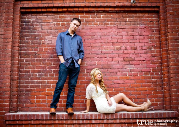 San Diego Wedding Photography: Engagement Photos in front of brick wall in Downtown San Diego 
