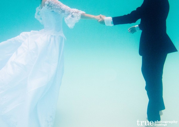 Jumping into swimming pool during Underwater Engagement Shoot with True Photography