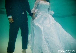 Jumping into swimming pool during Underwater Engagement Shoot with True Photography