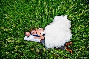 wedding couple in grass denver botanic gardens at chatfield