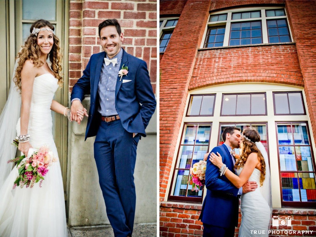 bride and groom in front of brick building