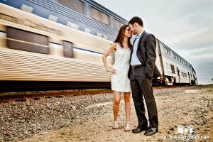 Engagement shoot of Del Mar Beach couple in front of train