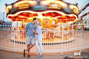 Engagement photo shoot of Mission Beach couple at carousel
