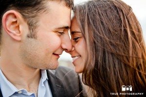Engagement shoot of Del Mar Beach couple kissing close up