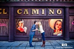 Little Italy Engagement shoot couple kissing in front of sign