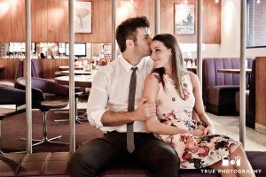 couple sitting at restaurant engagement photo downtown san diego
