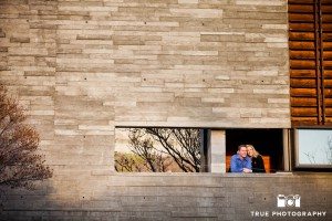 Little Italy Engagement shoot couple looking out from brick structure