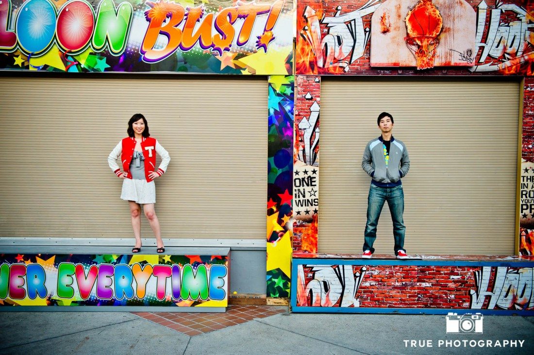 Engagement photo shoot of Mission Beach stylish couple with colorful background