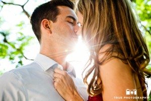 Old Town engagement shoot of couple kissing in sunlight