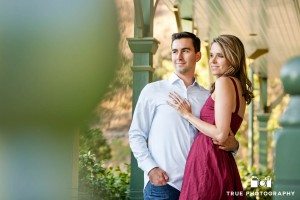 Old Town engagement shoot of couple standing against green post