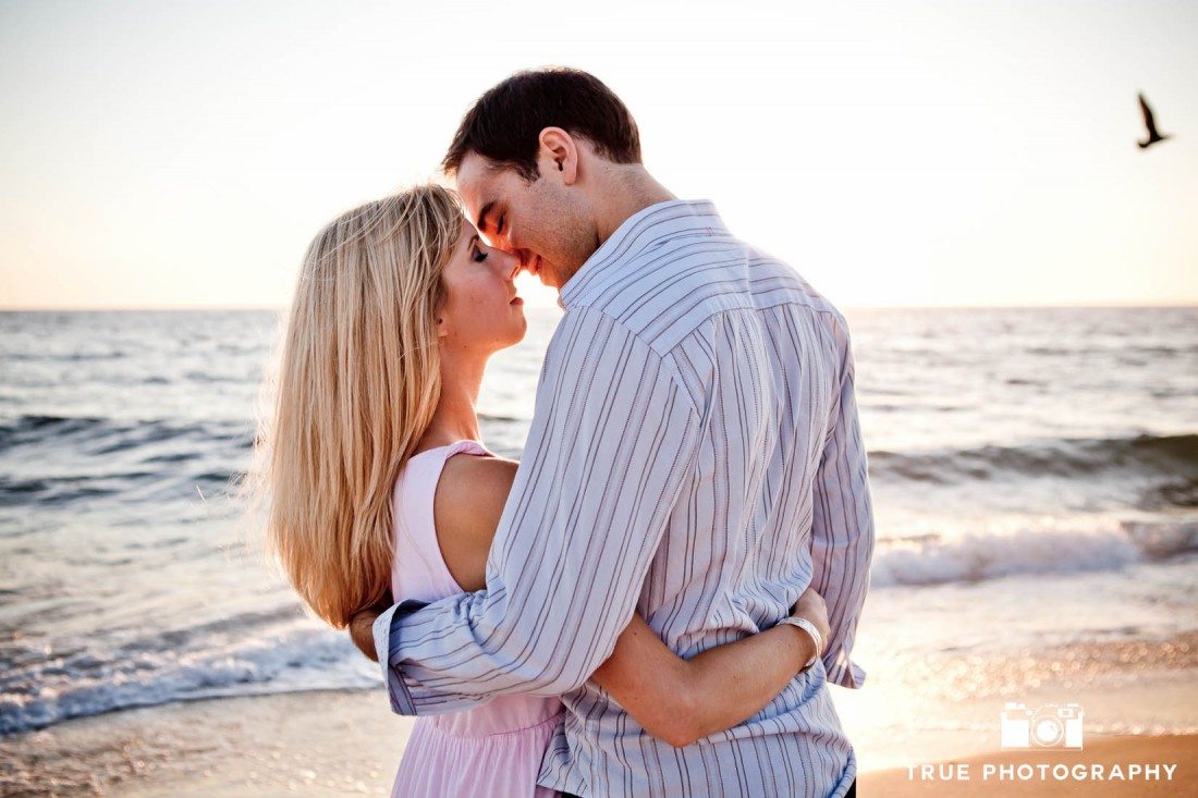 Windansea engagement photo couple kissing on sand