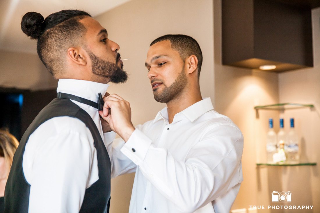 groom and groomsman getting ready