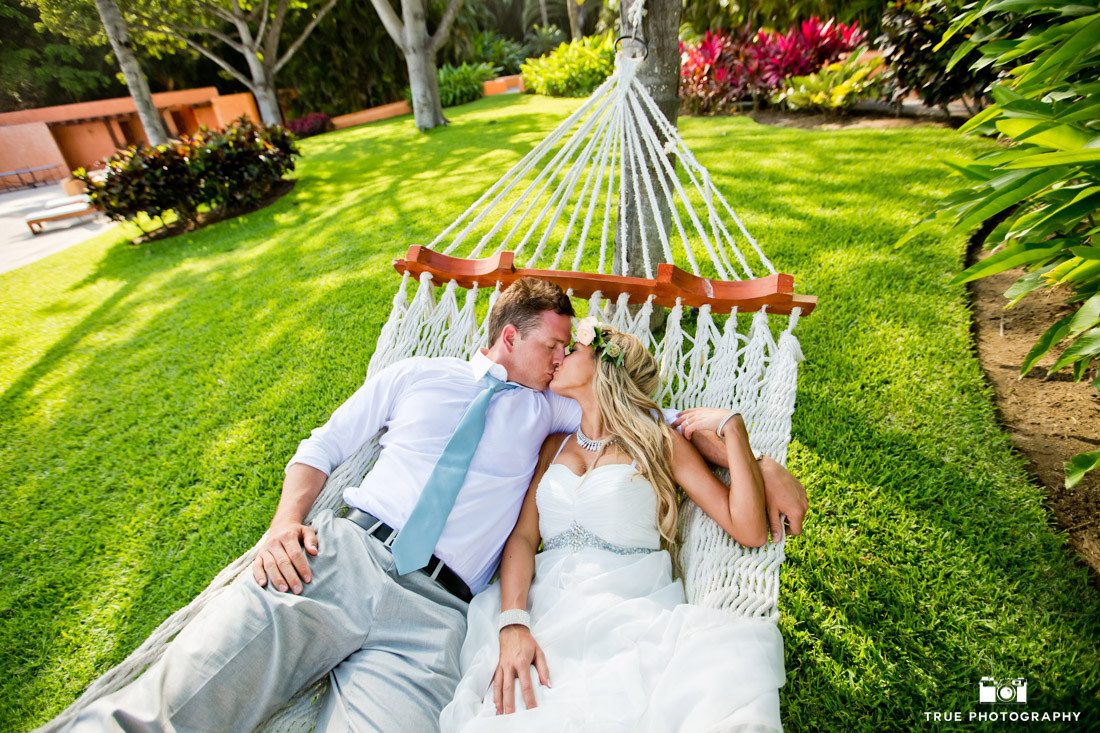 Wedding couple having an intimate kiss in a hammock at their Destination Wedding in Mexico.