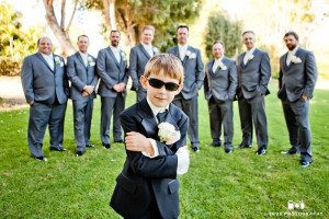 Young boy poses with Groomsmen at wedding