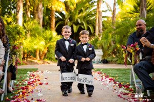Cute Ringbearers holds signs during wedding ceremony