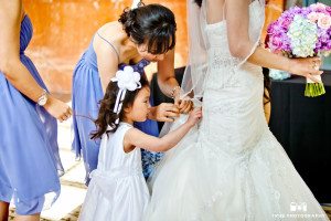 Young girl helps bride during pre-ceremony
