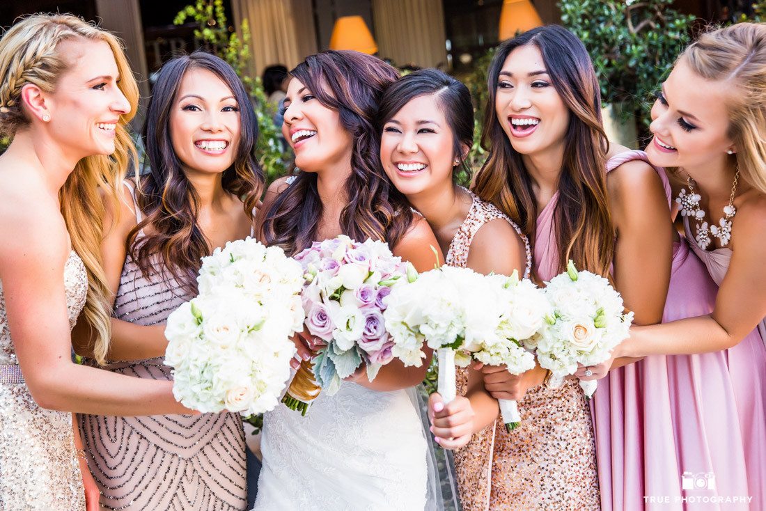 Laughing bridesmaids in different dresses