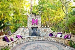 Outdoor fireplace decorated with purple and pink props