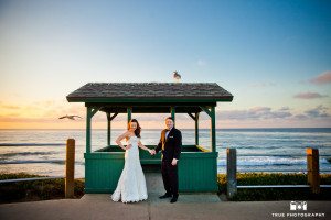 Bride and Groom hold hands during a colorful sunset