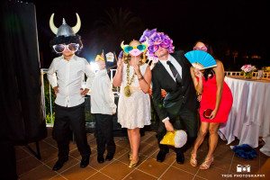 Guests at wedding reception have fun with photobooth
