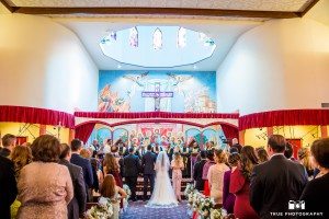 Couple stand at altar of Chaldean church after bride walks down aisle