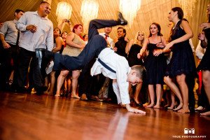 Young wedding guest dancing during reception