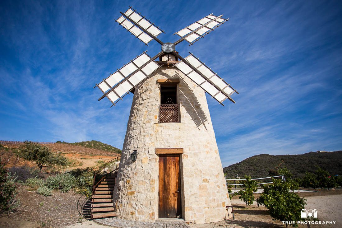 colorful photo of windmill against blue sky at cal-a-vie, vista, california