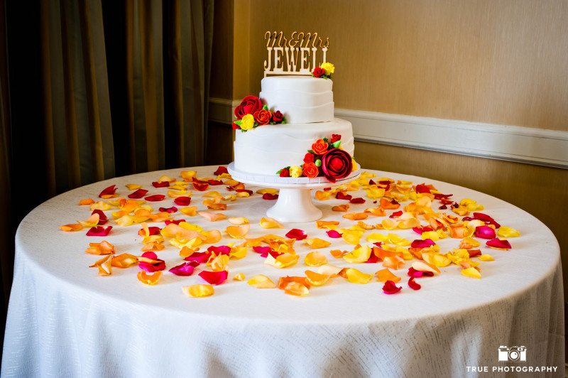 Minimal red and yellow cake with gold text cake topper