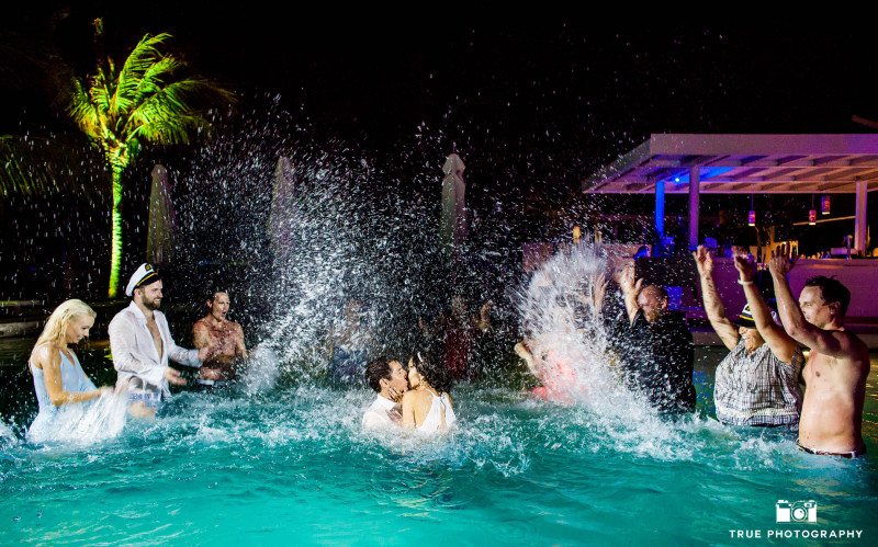 Bride and groom jump in pool for a kiss in Playa del Carmen.