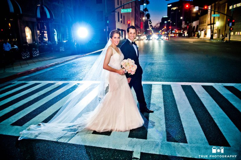 Bride and groom walking in San Diego during night photo