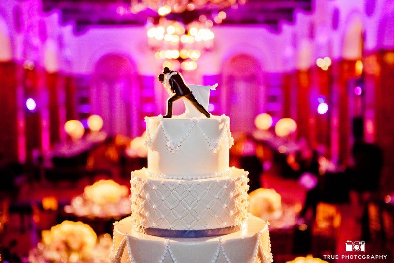 Classic wedding cake with cake topper of bride and groom kissing