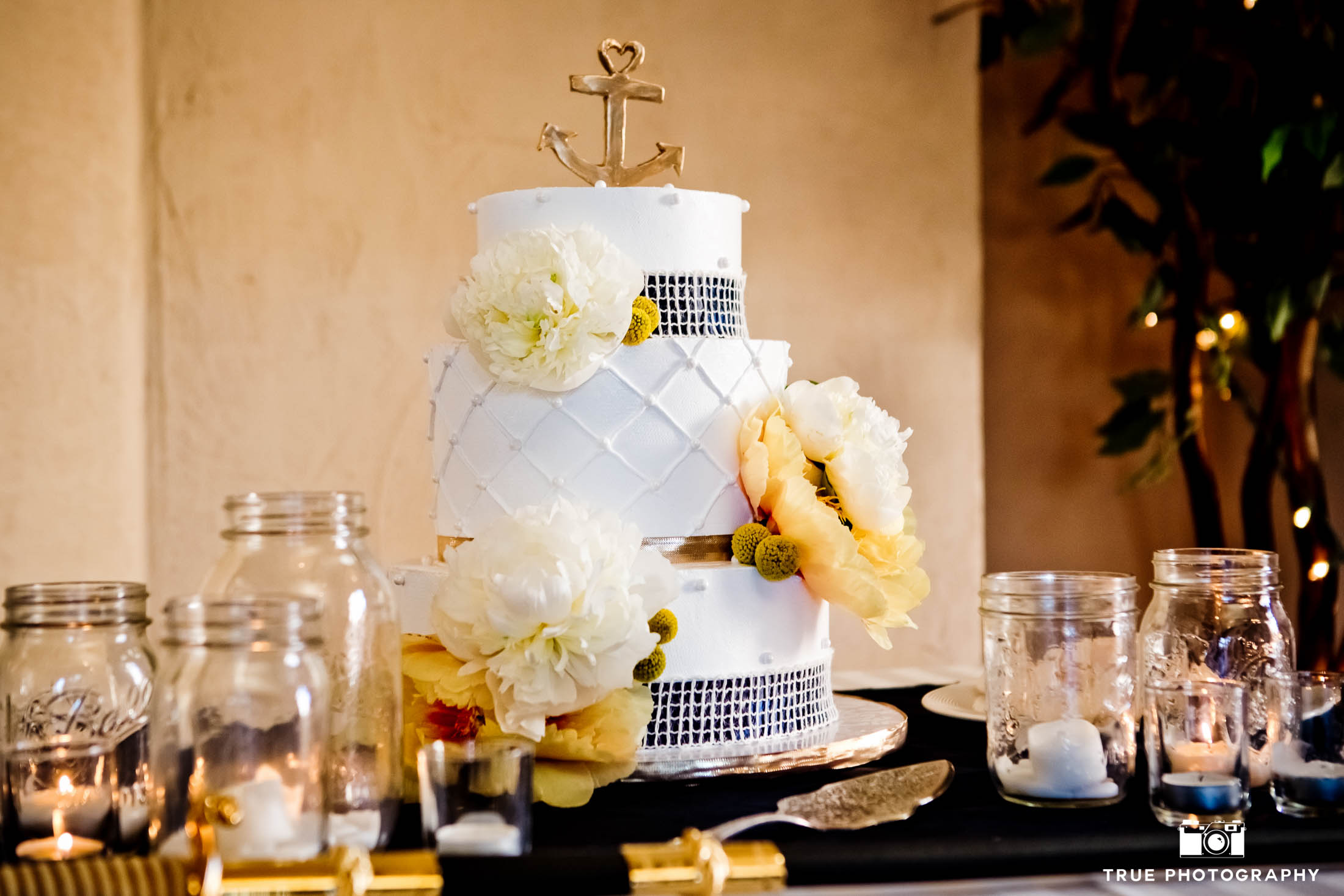 Classic wedding cake decorated with sailor wedding cake topper