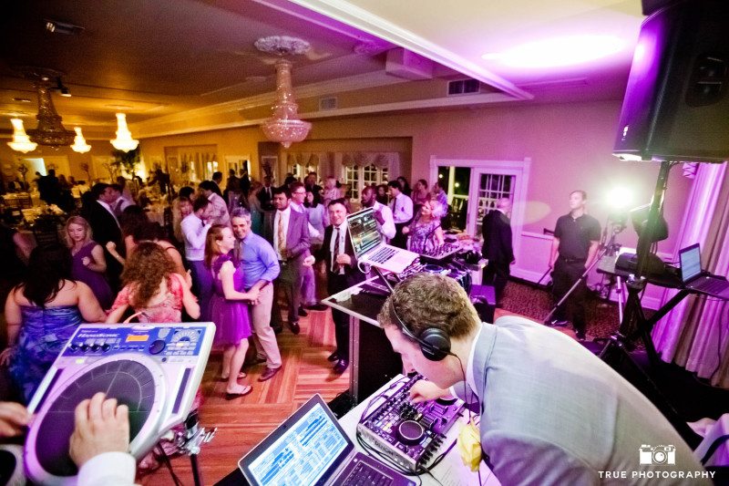 DJ plays music and performs for guests at wedding reception