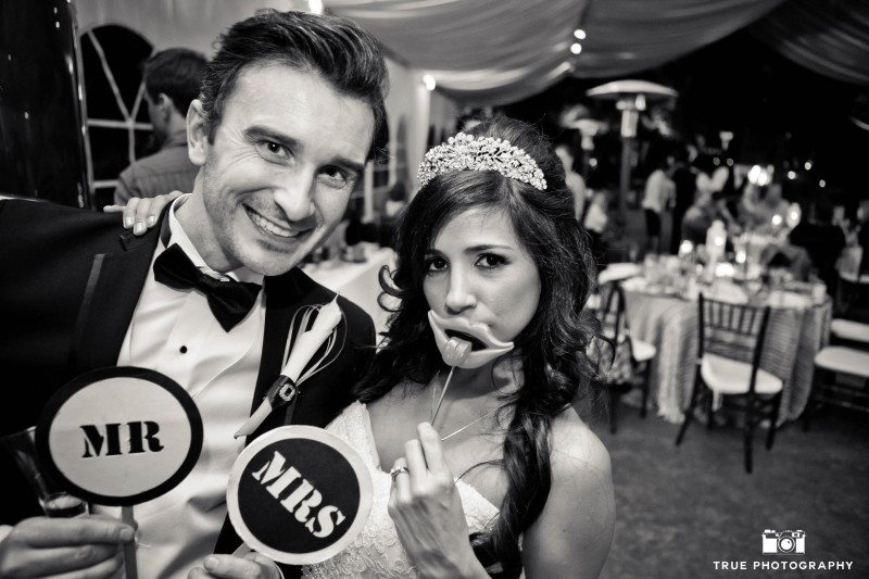 Wedding Couple have fun posing with photobooth props
