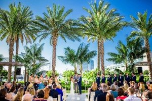 The Hilton San Diego Bayfront wedding couple, surrounded with Palm trees and blue sky