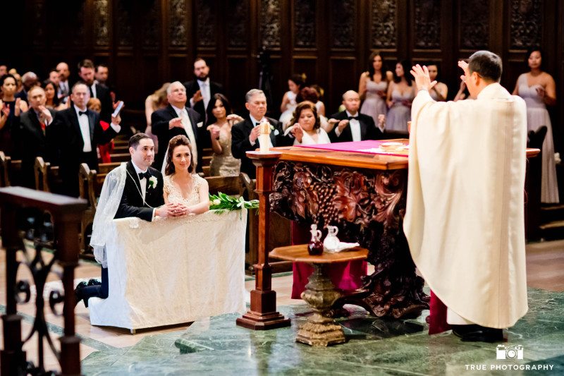 This Catholic wedding incorporates tradition during their Founders Chapel USD ceremony.