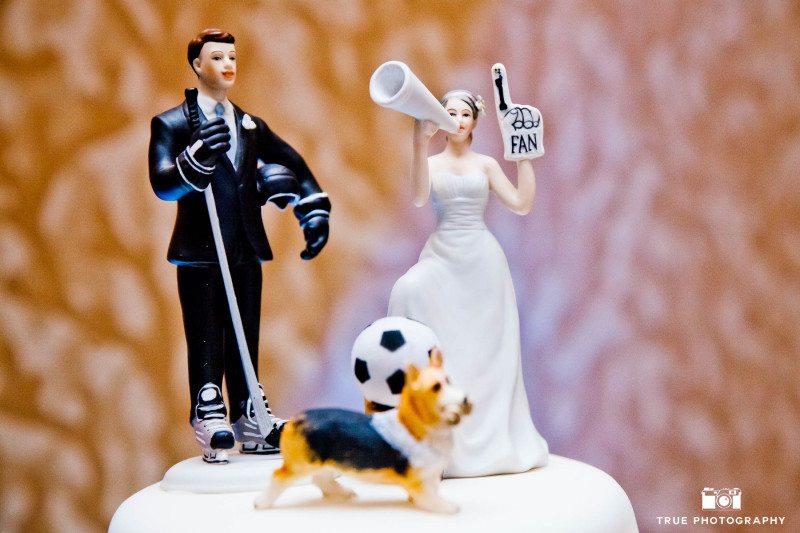 Cute hockey-inspired cake topper with wedding couple