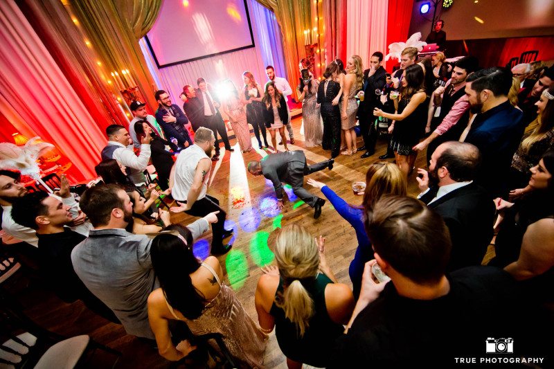 Wedding Guests form dance circle during wedding reception