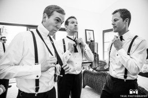 Groomsmen with style putting on bowties