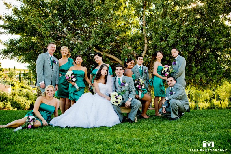 Cool bridal party dressed in green at winery wedding