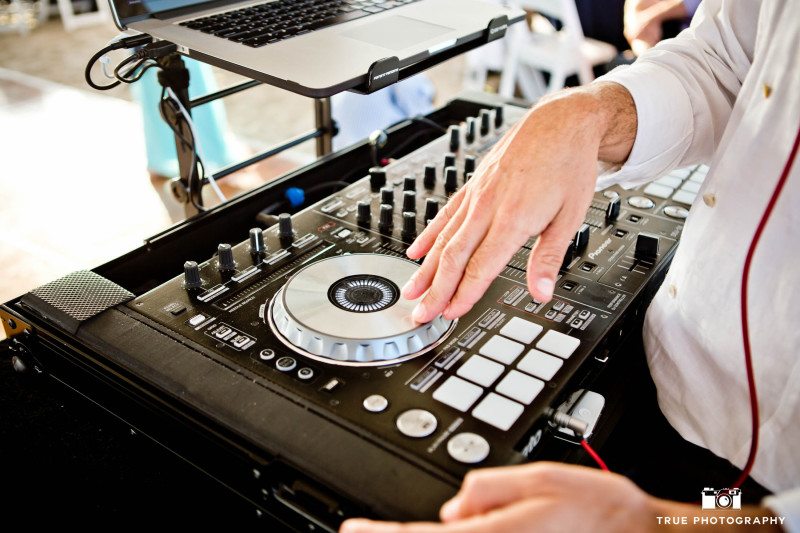 Close-up of DJ's hands using digital pad