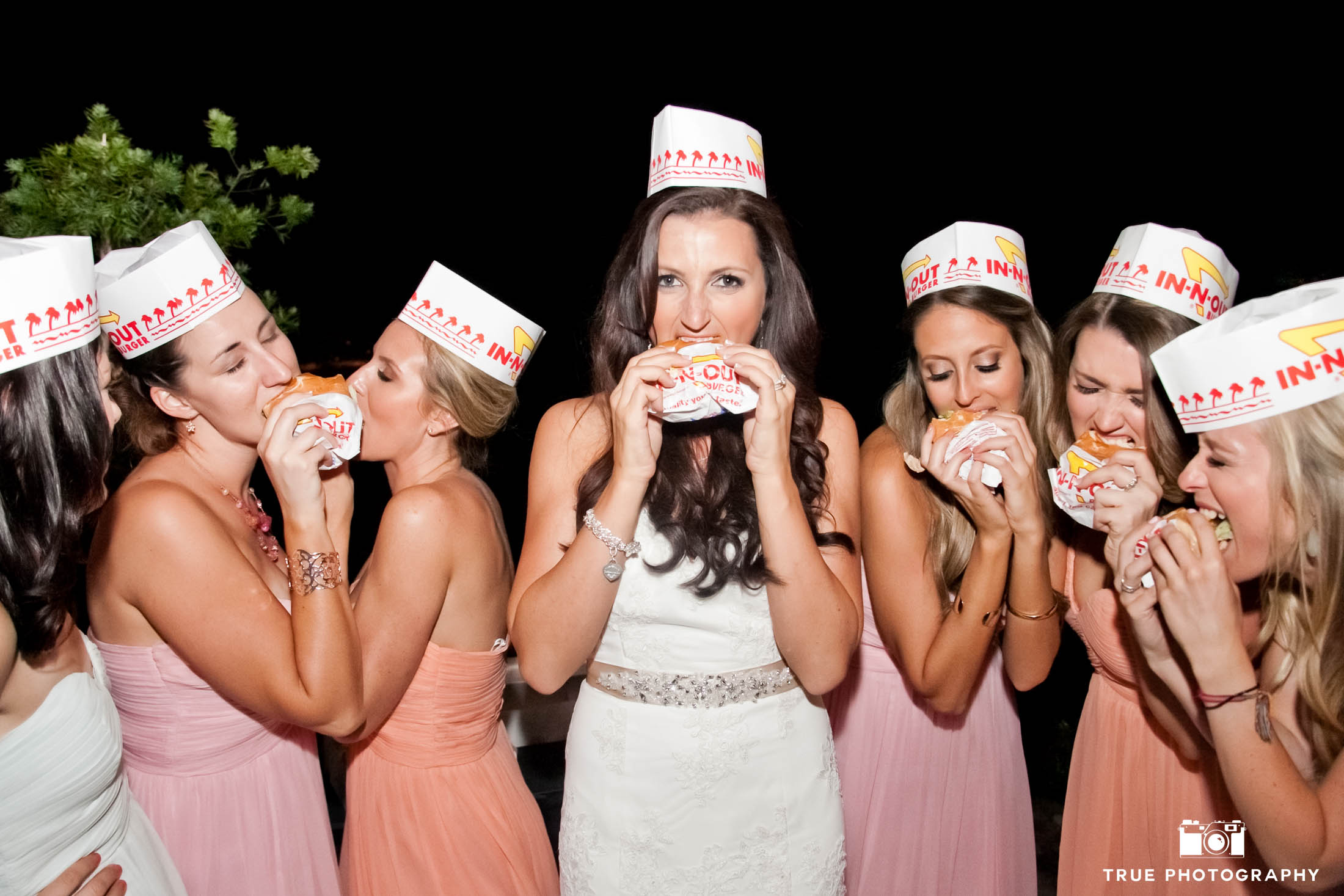 Bride and bridesmaids eat burgers from In N' Out during reception