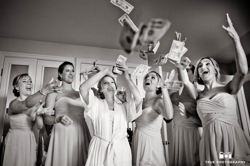 Bridesmaids make it rain as they toss money in the air before wedding ceremony