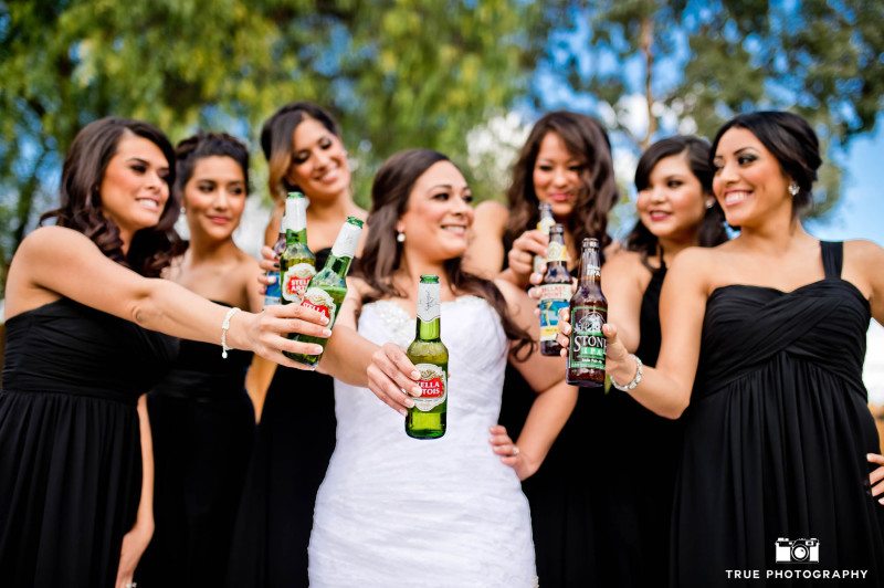 Bride and bridesmaids toast with craft beers
