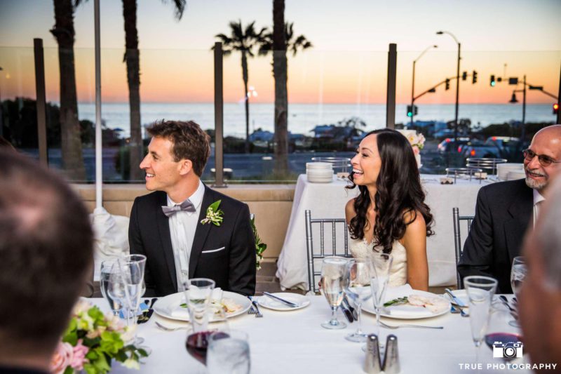 Cape Rey Carlsbad wedding couple at dinner reception table overlooking the ocean