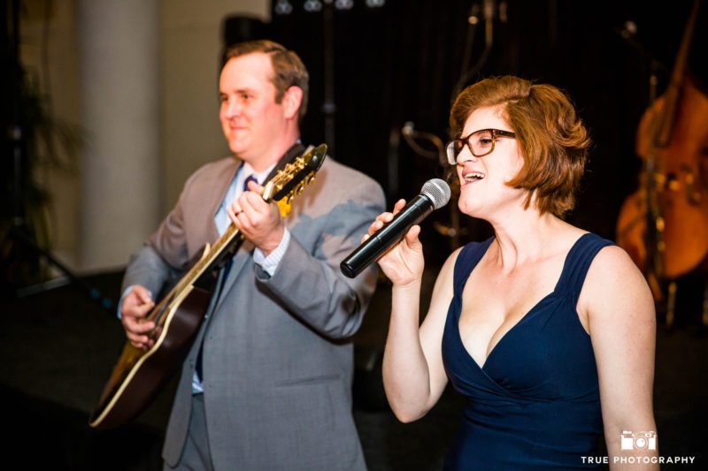 Groom plays guitar and performs with guest during Star Wars themed wedding reception