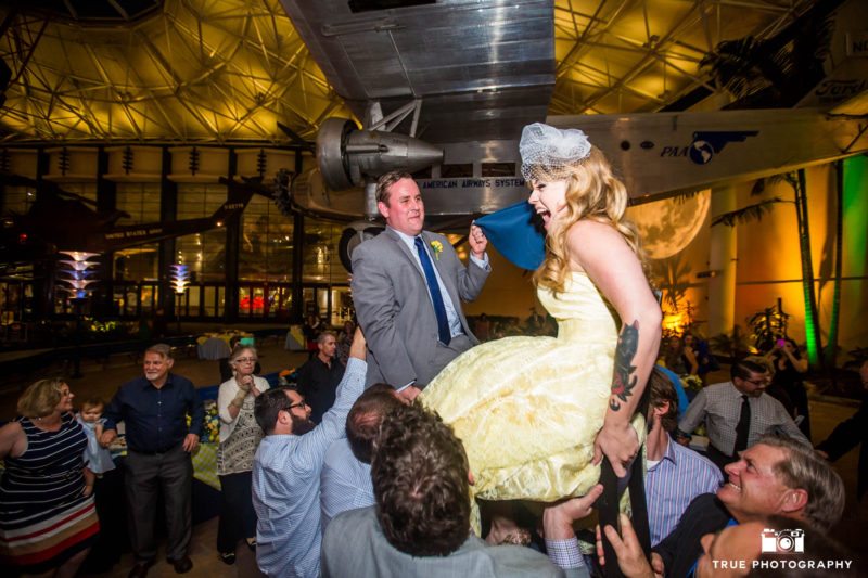 Guests lift Bride and Groom for Hora Dance during wedding reception