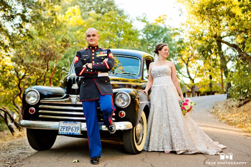 Military Groom and Bride pose with classic Ford car after wedding in Julian, California