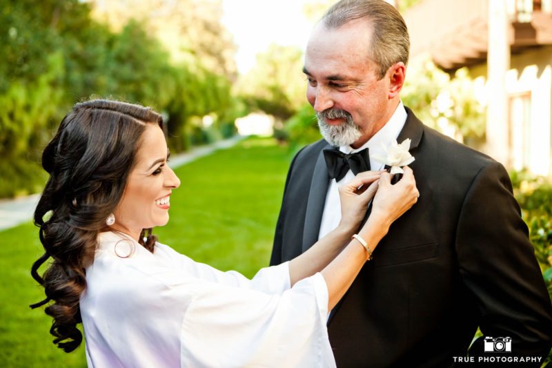 Cute moment with Bride looking at Dad as she puts on his boutonniere